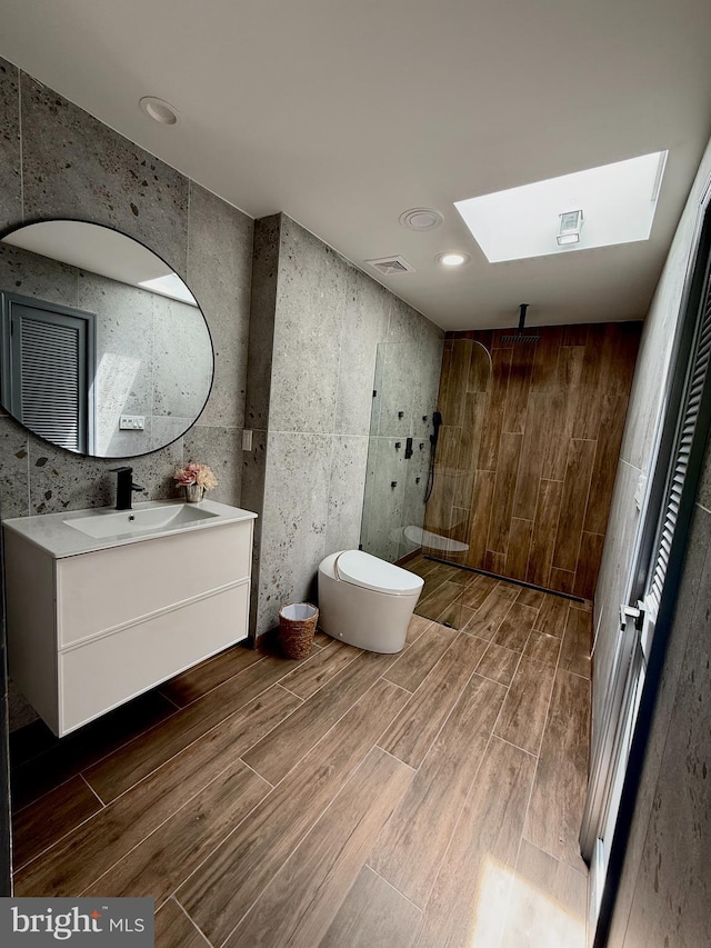 616 Webb Rd, Elkins Park, PA 19027 - full bath with wood finished floors, walk in shower, vanity, a skylight, and toilet