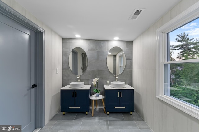 616 Webb Rd, Elkins Park, PA 19027 - bathroom with two vanities, tile patterned flooring, and tile walls
