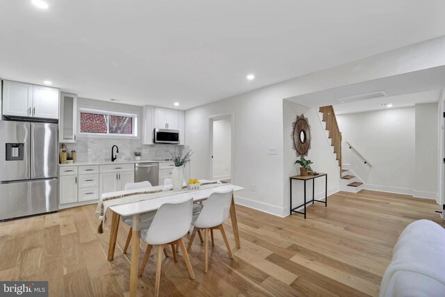 8120 Eastern Ave NW, Washington, DC 20012 - dining area with light wood-style floors, baseboards, stairs, and recessed lighting