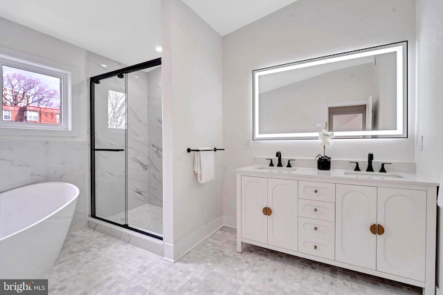 8120 Eastern Ave NW, Washington, DC 20012 - full bathroom featuring a marble finish shower, a soaking tub, double vanity, and baseboards