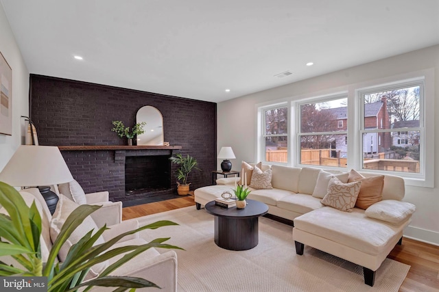 8120 Eastern Ave NW, Washington, DC 20012 - living room featuring wood finished floors, a brick fireplace, and recessed lighting