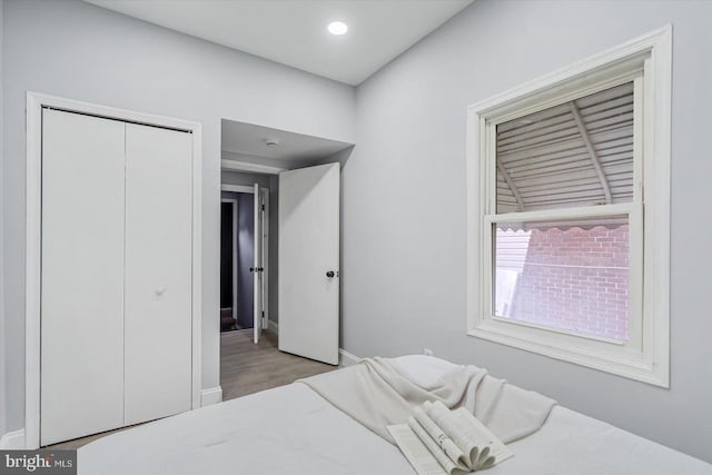 1711 Langley Rd, Baltimore, MD 21221 - bedroom featuring a closet, wood finished floors, and baseboards