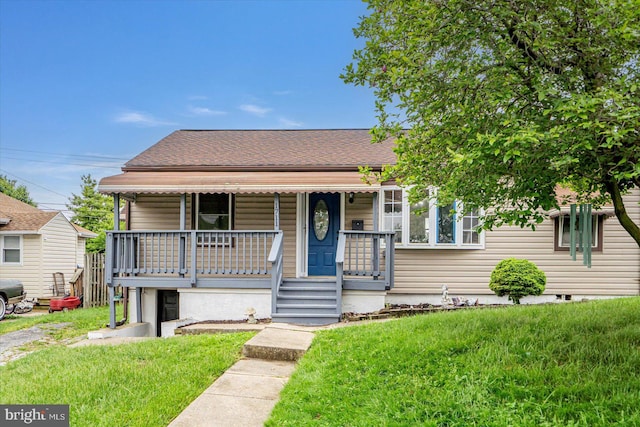 1711 Langley Rd, Baltimore, MD 21221 - bungalow featuring a porch, a front yard, and roof with shingles