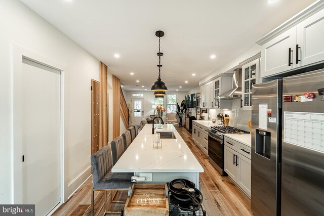 1919 Bennett Pl NE, Washington, DC 20002 - kitchen with appliances with stainless steel finishes, wall chimney range hood, a sink, light wood-type flooring, and recessed lighting
