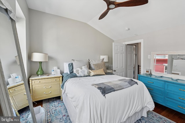 bedroom featuring vaulted ceiling, dark wood-style floors, and a ceiling fan