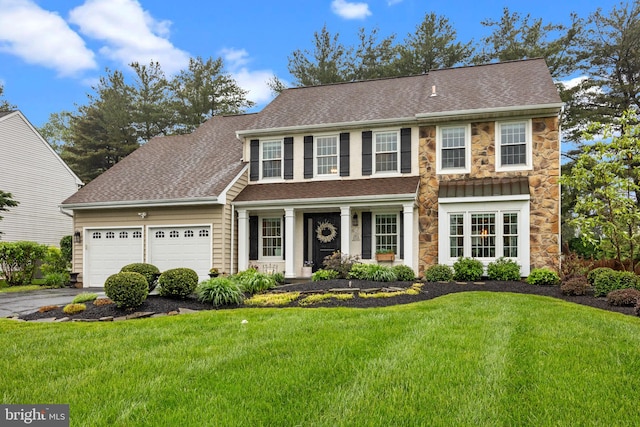 121 Beech Dr, Hatboro, PA 19040 - view of front of home featuring stone siding, a garage, a front yard, and driveway
