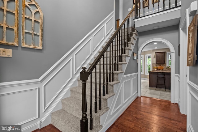 121 Beech Dr, Hatboro, PA 19040 - stairs featuring a decorative wall, wood finished floors, and wainscoting