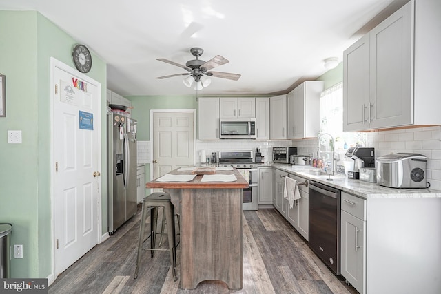 33 Laurel Rd, Millville, NJ 08332 - kitchen with appliances with stainless steel finishes, a sink, a kitchen island, dark wood-style floors, and a ceiling fan