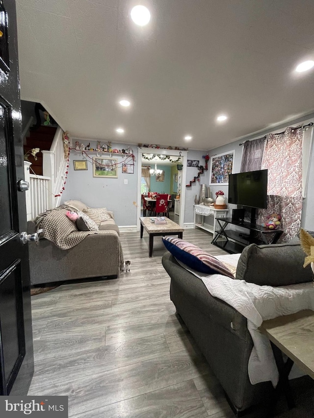 living area featuring stairs, recessed lighting, wood finished floors, and baseboards