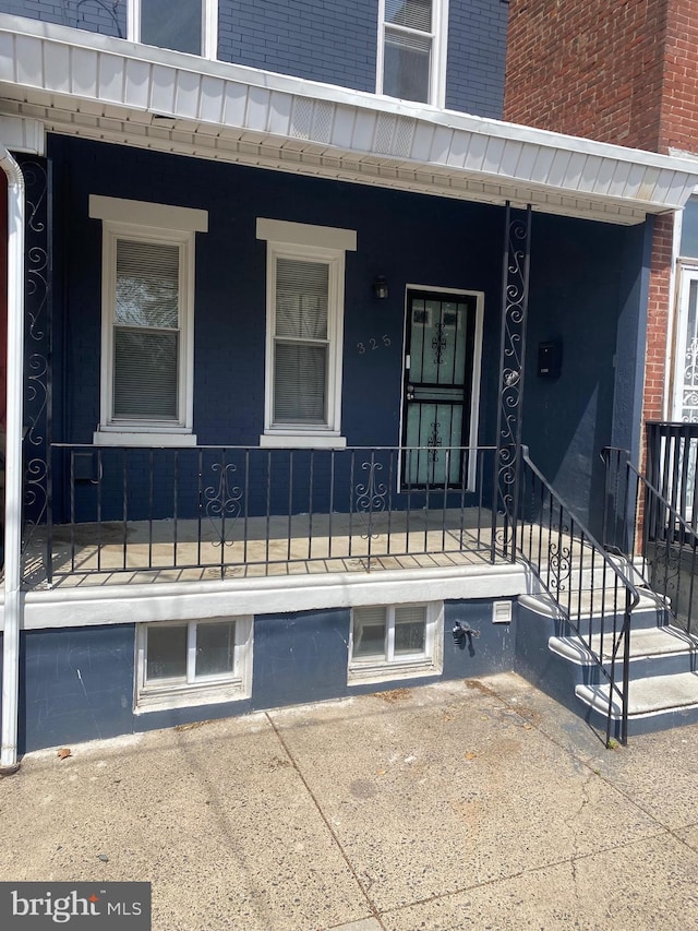doorway to property featuring a porch