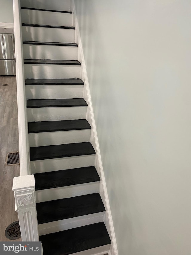 stairway featuring wood finished floors