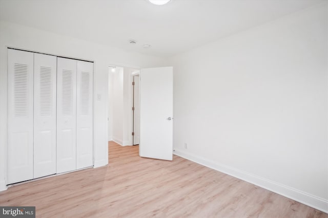 12001 Old Columbia Pike Unit 514, Silver Spring, MD 20904 - unfurnished bedroom featuring light wood finished floors, baseboards, and a closet