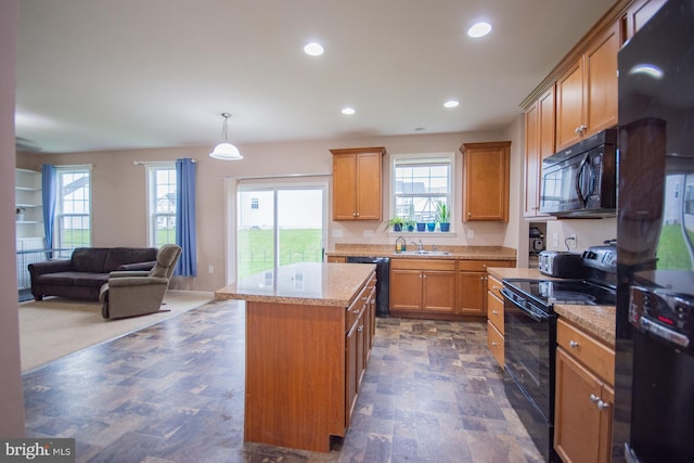 173 Tuscany Trl, Hedgesville, WV 25427 - kitchen with black appliances, a center island, recessed lighting, brown cabinetry, and a sink