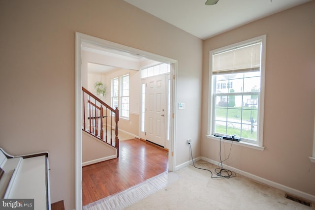 173 Tuscany Trl, Hedgesville, WV 25427 - entryway featuring healthy amount of natural light, stairway, baseboards, and carpet