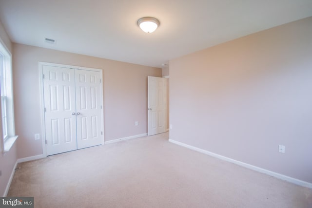173 Tuscany Trl, Hedgesville, WV 25427 - unfurnished bedroom featuring a closet, light carpet, and baseboards