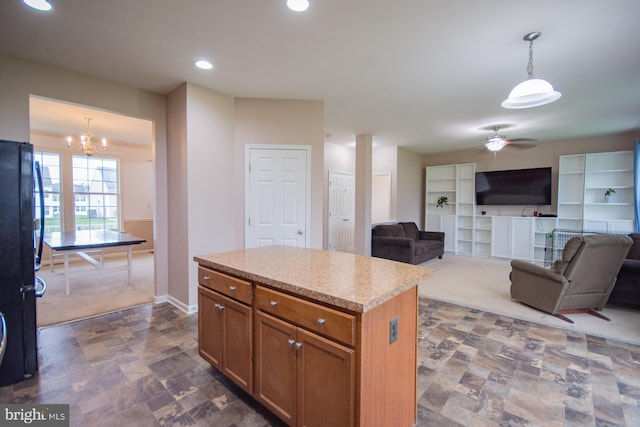 173 Tuscany Trl, Hedgesville, WV 25427 - kitchen with brown cabinets, stone finish flooring, a ceiling fan, pendant lighting, and freestanding refrigerator
