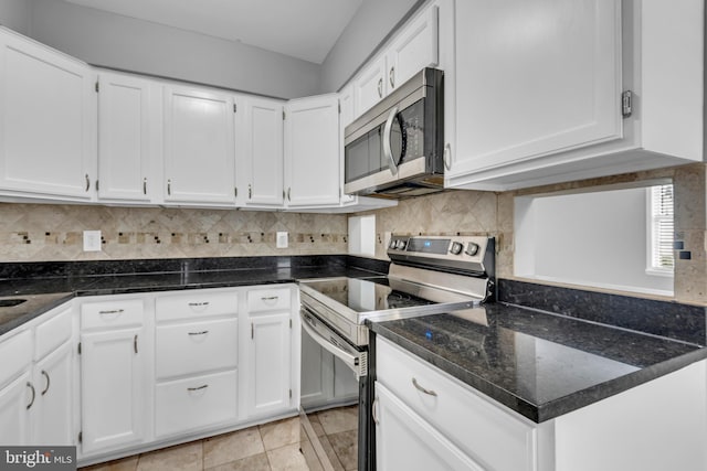 1223 Kendrick Rd, Baltimore, MD 21237 - kitchen with stainless steel appliances, white cabinets, tasteful backsplash, dark stone countertops, and light tile patterned flooring