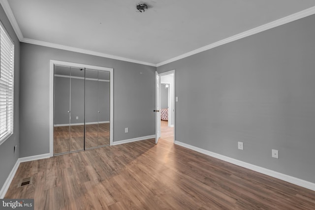 1223 Kendrick Rd, Baltimore, MD 21237 - unfurnished bedroom with baseboards, wood finished floors, a closet, and crown molding