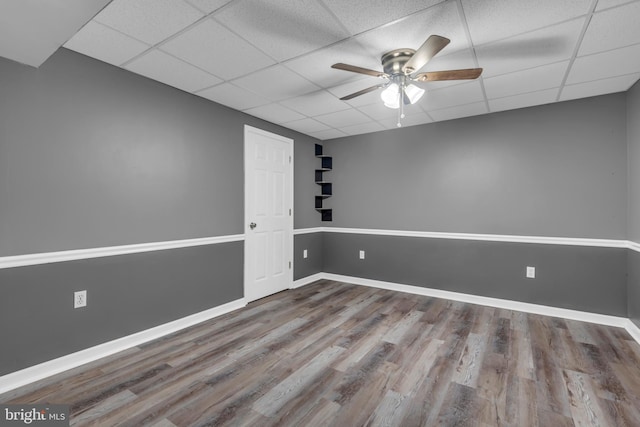 1223 Kendrick Rd, Baltimore, MD 21237 - unfurnished room featuring a paneled ceiling, wood finished floors, a ceiling fan, and baseboards