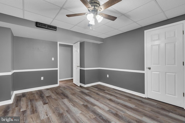 1223 Kendrick Rd, Baltimore, MD 21237 - finished below grade area featuring a drop ceiling, wood finished floors, a ceiling fan, and baseboards