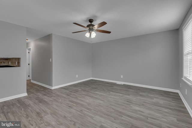 1223 Kendrick Rd, Baltimore, MD 21237 - empty room with a ceiling fan, wood finished floors, baseboards, and plenty of natural light