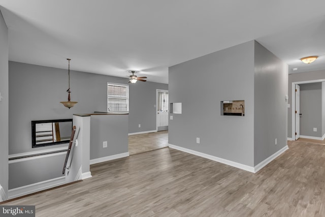 1223 Kendrick Rd, Baltimore, MD 21237 - unfurnished living room with light wood-style flooring, baseboards, and ceiling fan