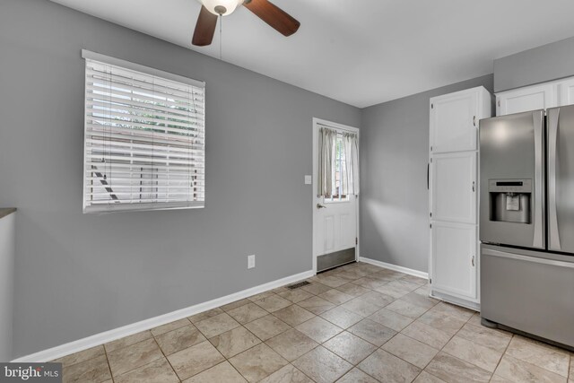1223 Kendrick Rd, Baltimore, MD 21237 - kitchen featuring stainless steel fridge, a ceiling fan, white cabinetry, and baseboards