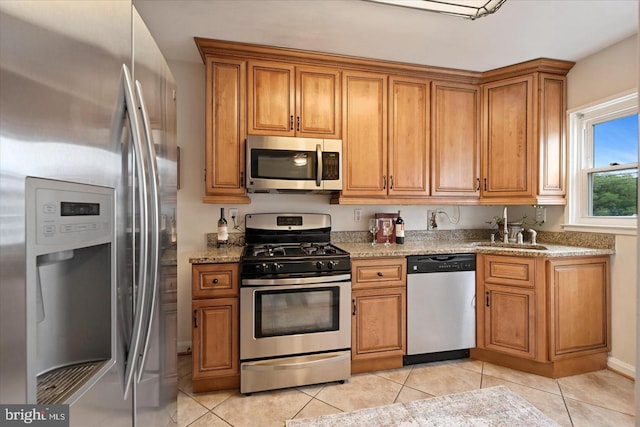 7849 Charlesmont, Dundalk, MD 21222 - kitchen featuring appliances with stainless steel finishes, a sink, brown cabinets, and light tile patterned flooring