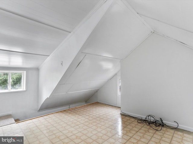 bonus room featuring tile patterned floors and vaulted ceiling
