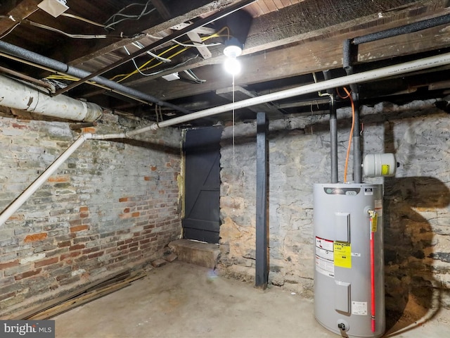 unfinished basement featuring water heater