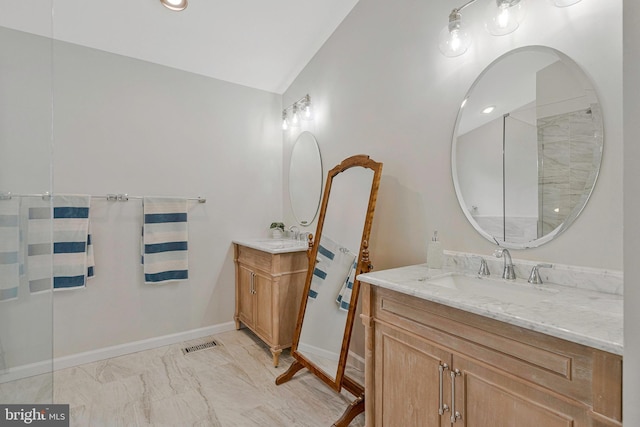 12641 Terrymill Dr, Herndon, VA 20170 - full bath with two vanities, marble look tile flooring, baseboards, and vaulted ceiling