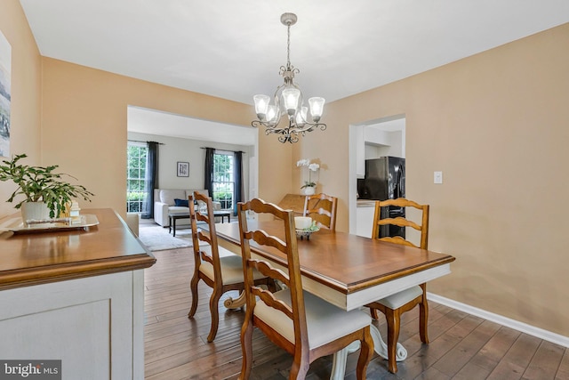 12641 Terrymill Dr, Herndon, VA 20170 - dining room featuring wood finished floors, a chandelier, and baseboards