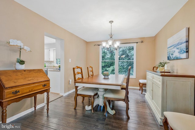 12641 Terrymill Dr, Herndon, VA 20170 - dining space with a chandelier, dark wood-style flooring, and baseboards