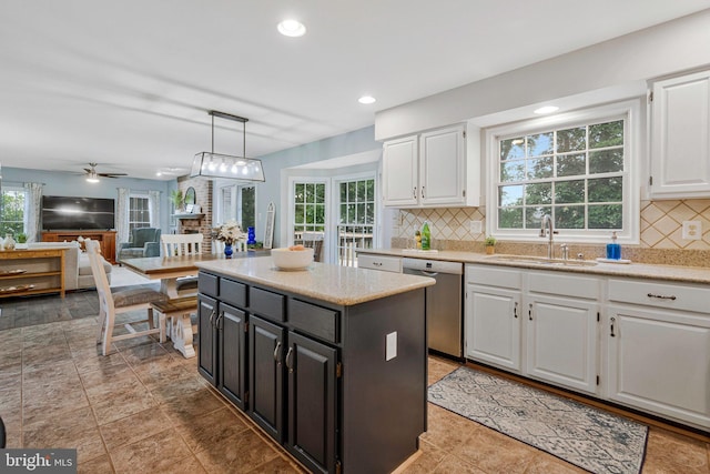 12641 Terrymill Dr, Herndon, VA 20170 - kitchen featuring stainless steel dishwasher, a sink, white cabinets, decorative backsplash, and dark cabinets