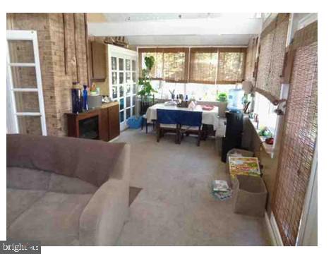 4098 Camelot, Dumfries, VA 22026 - sunroom / solarium featuring french doors, carpet, and brick wall