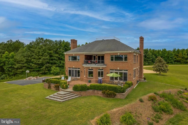 46369 Hattons Rest Ln, Lexington Park, MD 20653 - rear view of house featuring a balcony, a chimney, a yard, a patio area, and brick siding