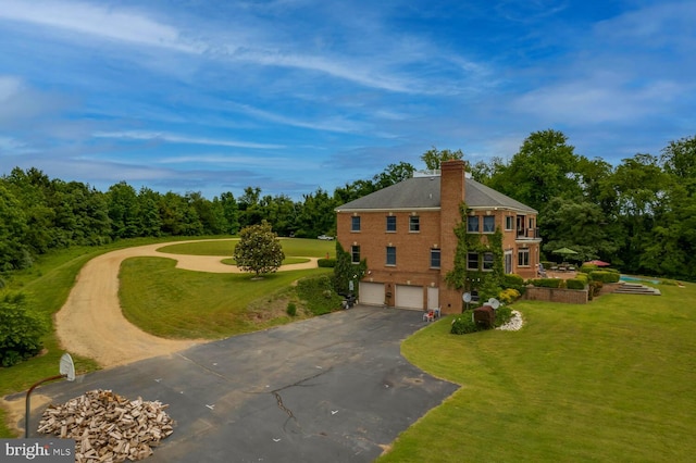 46369 Hattons Rest Ln, Lexington Park, MD 20653 - view of front facade with asphalt driveway, an attached garage, a chimney, and a front yard