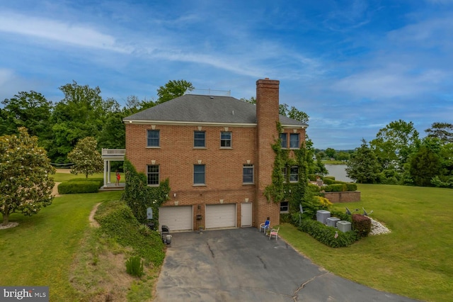 46369 Hattons Rest Ln, Lexington Park, MD 20653 - view of side of home featuring a garage, a chimney, driveway, and brick siding