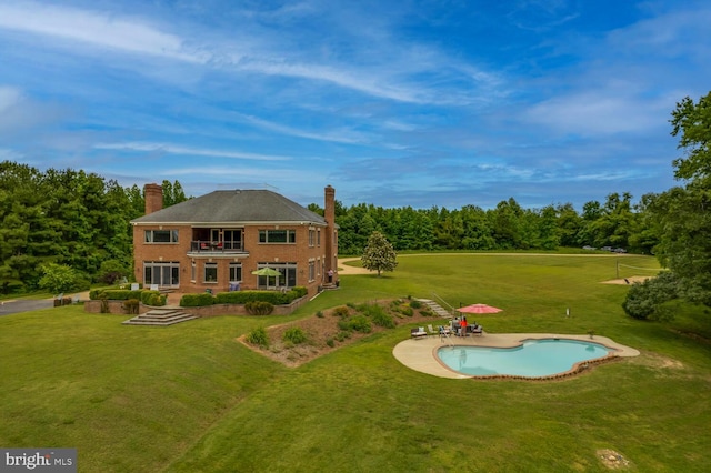 46369 Hattons Rest Ln, Lexington Park, MD 20653 - rear view of property with a lawn, a balcony, an outdoor pool, and a chimney
