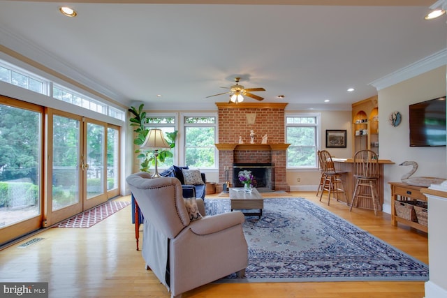 46369 Hattons Rest Ln, Lexington Park, MD 20653 - living area featuring crown molding, a ceiling fan, light wood-type flooring, recessed lighting, and a brick fireplace