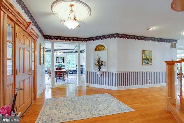 46369 Hattons Rest Ln, Lexington Park, MD 20653 - foyer entrance with ornate columns, light wood finished floors, and a wainscoted wall