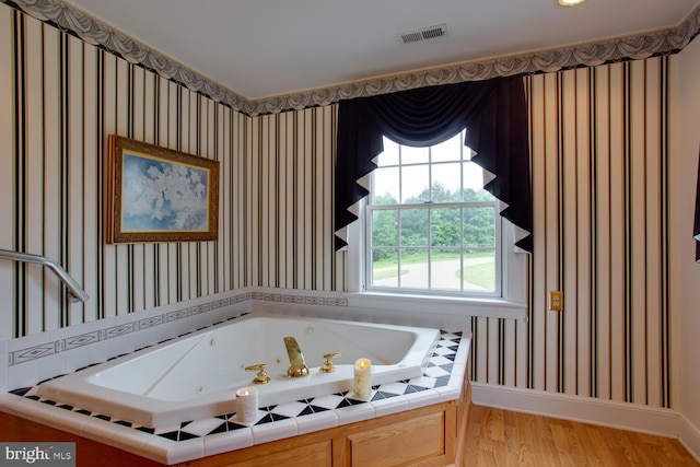 46369 Hattons Rest Ln, Lexington Park, MD 20653 - bathroom featuring a jetted tub, wood finished floors, and wallpapered walls