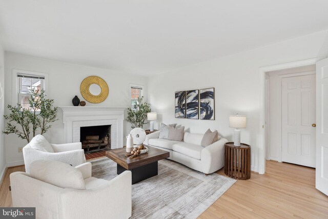 1725 Oakcrest Dr, Alexandria, VA 22302 - living area with light wood-style floors, a brick fireplace, and baseboards