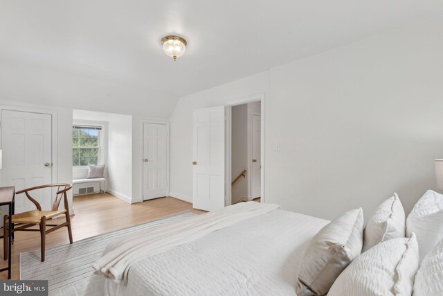 1725 Oakcrest Dr, Alexandria, VA 22302 - bedroom with light wood-type flooring, vaulted ceiling, and baseboards