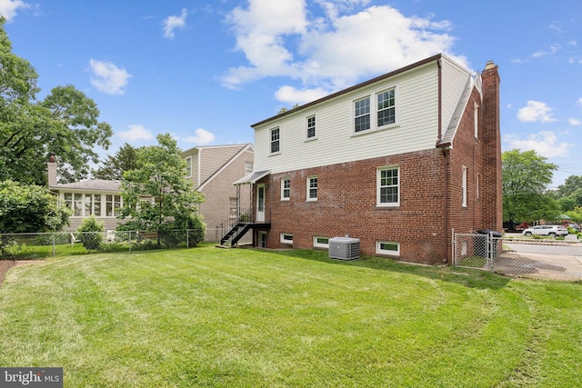 1725 Oakcrest Dr, Alexandria, VA 22302 - back of property with a chimney, central air condition unit, and brick siding