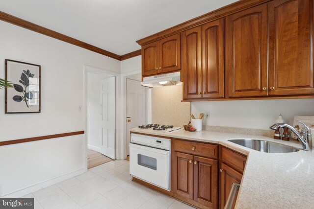 1725 Oakcrest Dr, Alexandria, VA 22302 - kitchen with white appliances, a sink, under cabinet range hood, ornamental molding, and brown cabinetry