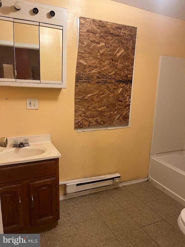 2412 N Corlies St, Philadelphia, PA 19132 - full bath with baseboard heating, vanity, a bath, and toilet