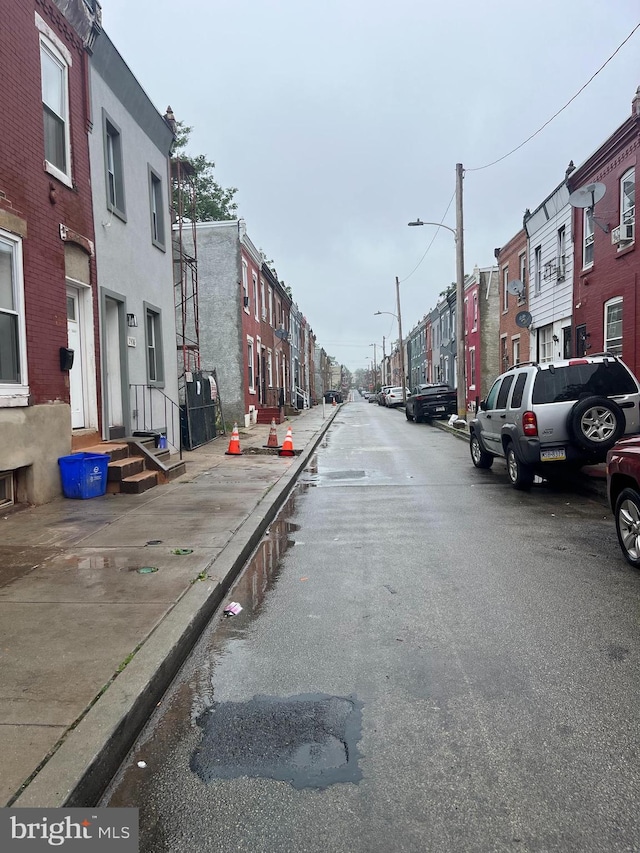 2412 N Corlies St, Philadelphia, PA 19132 - view of asphalt street with street lighting, a residential view, curbs, and sidewalks