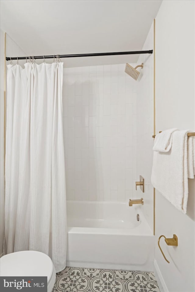 bathroom with tile patterned floors, shower / bath combo with shower curtain, toilet, and baseboards