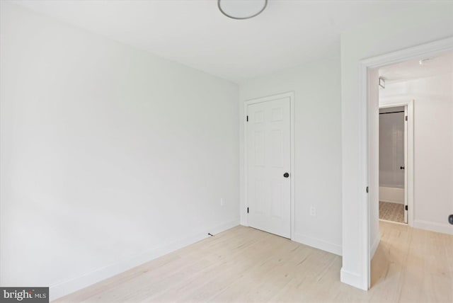 unfurnished bedroom featuring light wood finished floors and baseboards